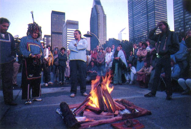 Native American elders create the fire and offer an inspirational message at the sunrise ceremony on the grounds of the United Nations. New York City, USA