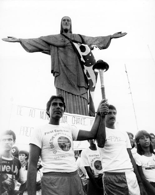 Sunset Ceremony overlooking Bay of Rio de Janeiro in front of the Christ of Corcovado statue garlanded with a blue and white “Paz” (peace) banner for the occasion. Rio de Janeiro, Brazil