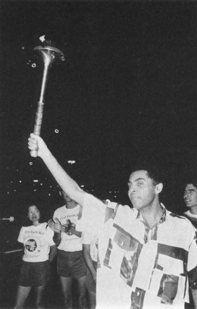 Leading entertainer, Gilberto Gil holding torch at peace concert he organized with the best of Brazil’s popular musicians. Rio De Janeiro, Brazil