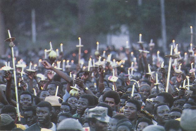 Crowds with candles lit from the torch of peace. Burkina Faso