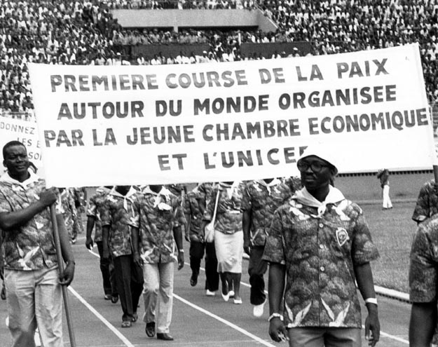 50,000 plus crowd gathered in stadium celebrating torch’s arrival. Abidjan, Cote d’ Ivoire