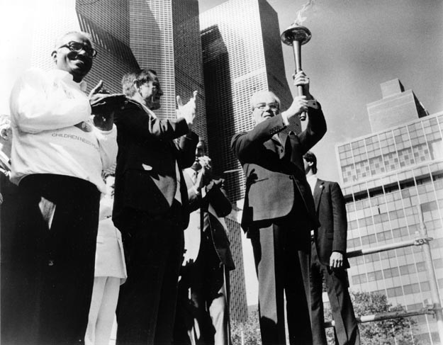 United Nations Secretary General, Javier Perez de Cuellar, with torch at opening ceremony. New York City, USA