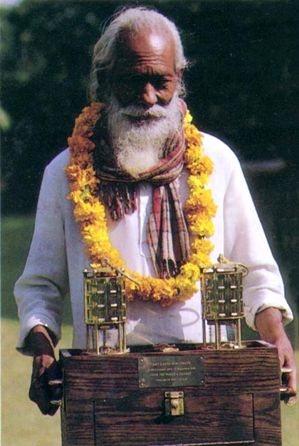 Holy man with miner’s lamps transporting the fire. Mathura, India