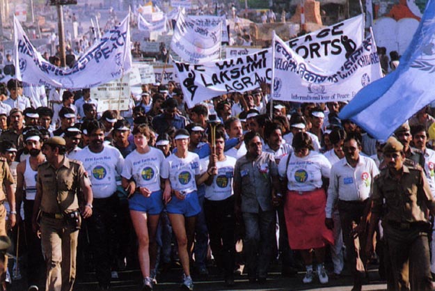 Going slowly through the streets with an estimated 100,000 participants and spectators mingled together. Hyderbad, India