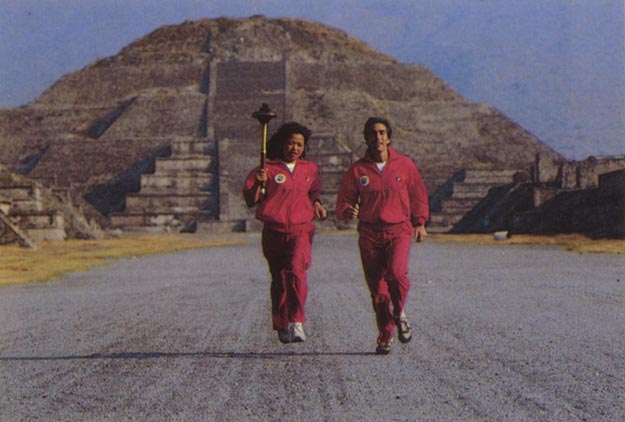 Running having just lit cauldron on top of Pyramid Temple of the Sun. Teotihuacán, Mexico