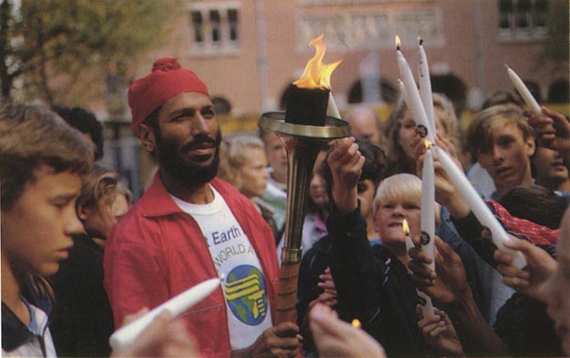 Peace candles being lit from the torch. Amsterdam, Netherlands