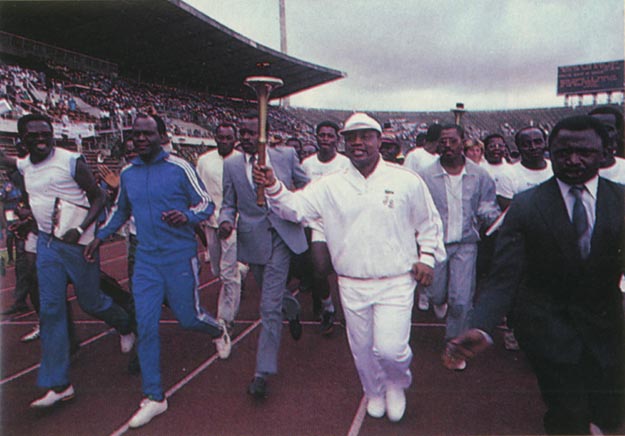 President Ibrahim Bababgida delighted 60,000 spectators by an impromptu run with torch. Lagos, Nigeria