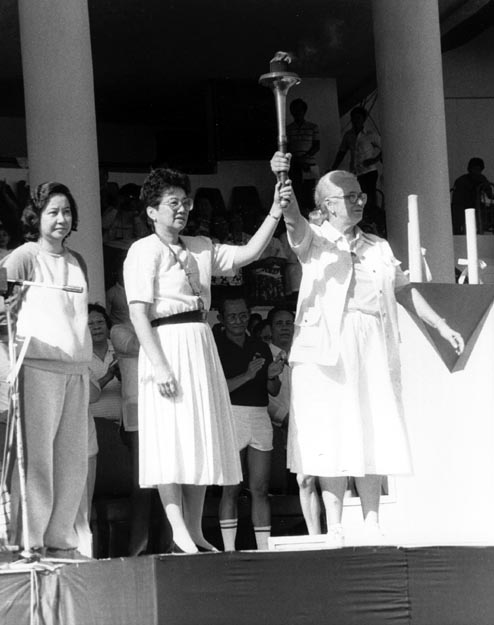 President Corazon Aquino with torch after delivering a stirring speech about the need for world cooperation to an estimated crowd of 500,000 people. Manila, Philippines