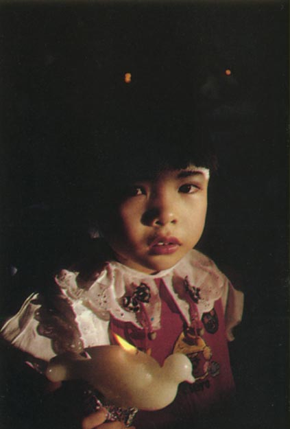 Child with dove candle. Singarore