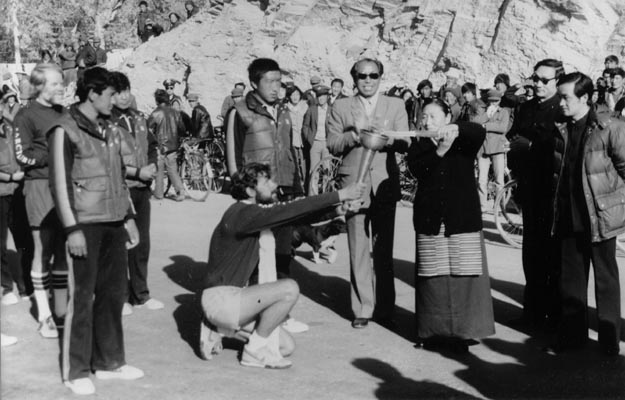 Tibetan spiritual leader lights torch carried up Mt. Everest by American and Chinese mountaineers. Lhasa, Tibet